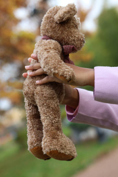 istock teddy bear in the hands of a child 1282723676