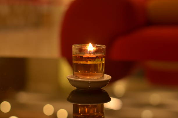 istock Decorative Spa Candle or tea light on glass table with blurred background 1282723711