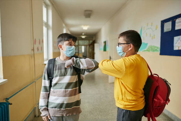 istock School boys using elbow bump as an alternative hands during COVID-19 pandemic 1282723861