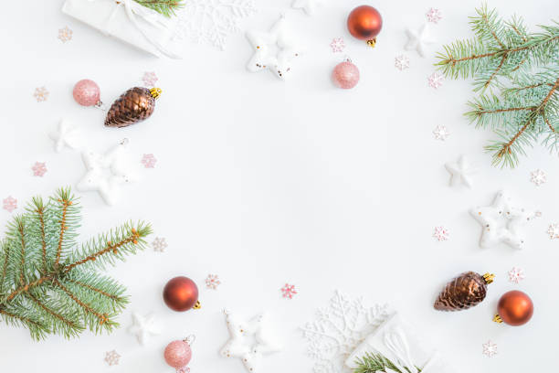 istock Flat lay frame with fir branches, christmas baubles decoration and gift box on a white background 1282725645