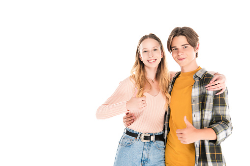 Smiling teenagers embracing and showing like isolated on white