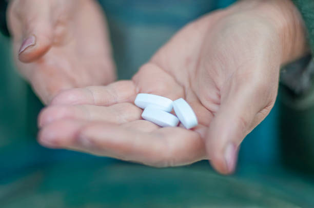 istock arm holds effective white antiviral pills from pharmacy 1282727021