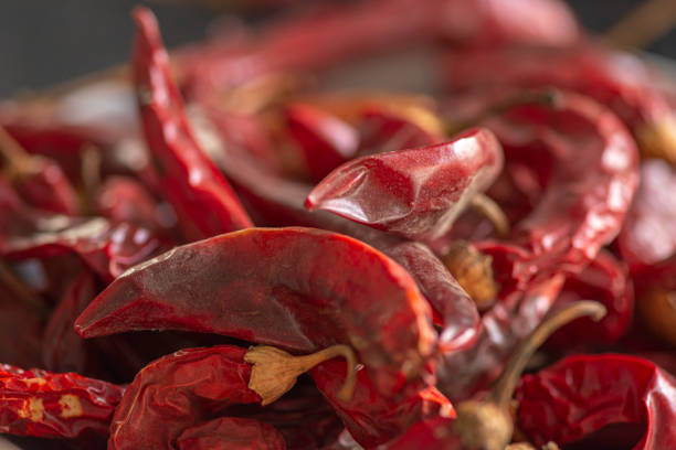 Dried red chili or chilli cayenne pepper on black marble background, close up, selective focus