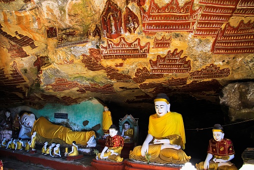Hpa An (Sadan cave), Myanmar - December 11. 2015: View into buddhist cave with colorful buddha statues and mural paintings