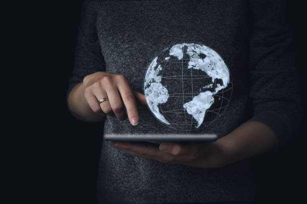 istock world map hologram and hand writing in laptop. Research and development software concept. Planet control. 1282727033