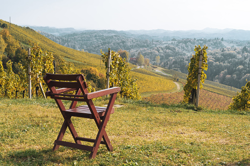 Chairs in front of the panoramic view of the hills of southern styria