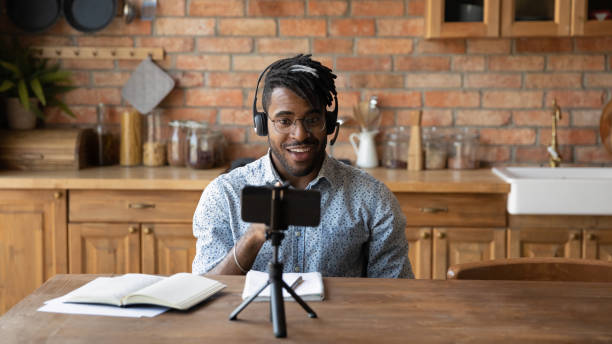 istock African American male vlogger record video on cellphone 1282728202