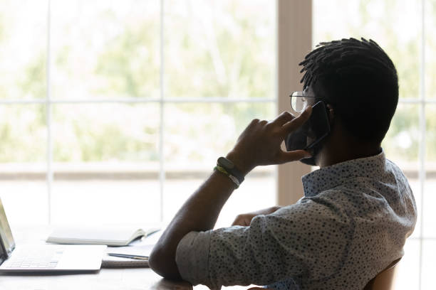 istock Biracial male employee talk with client on cellphone call 1282728211