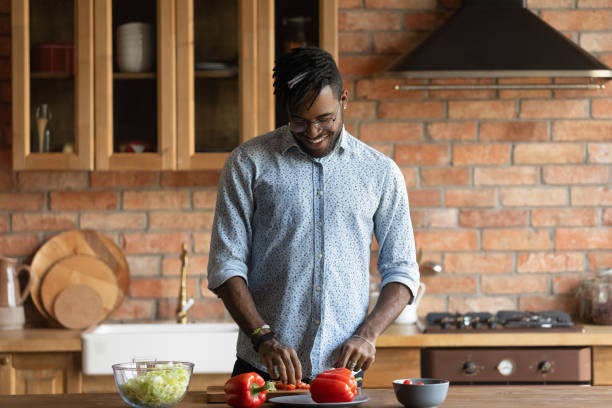 istock Smiling biracial man cooking healthy salad in kitchen 1282728263