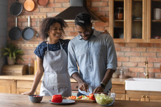 istock Happy biracial couple cooking together at home kitchen 1282728277