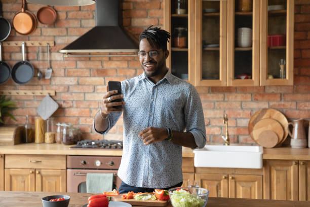 istock Happy biracial man talk on video call cooking at home 1282728279