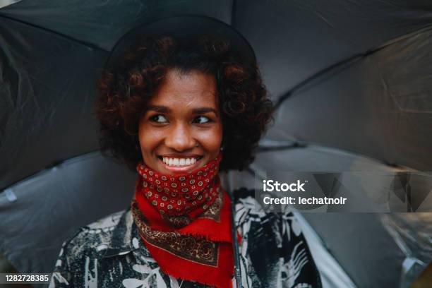 Portrait Of A Young Black Woman Wearing A Neck Gaiter Stock Photo - Download Image Now