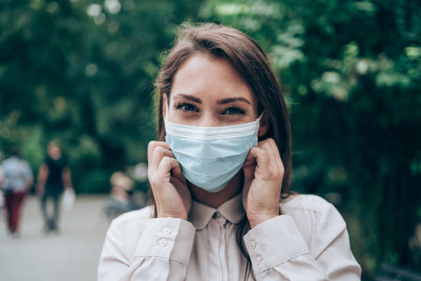 istock Woman with protective face mask outdoors. 1282729718