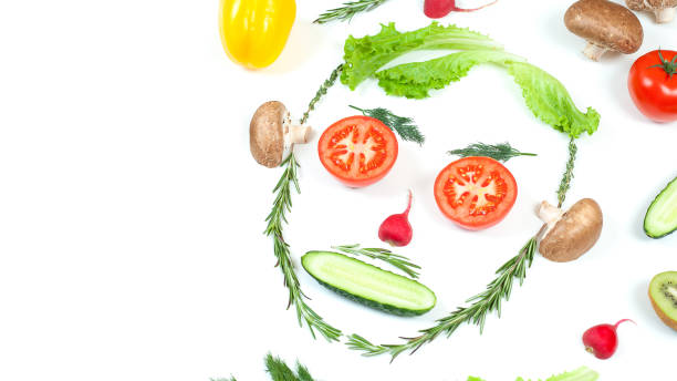 istock Funny face from different vegetables tomatoes, cucumber, radish, dill and rosemary isolated on white background. Healthy eating and vegan food concept. Kitchen 1282734062