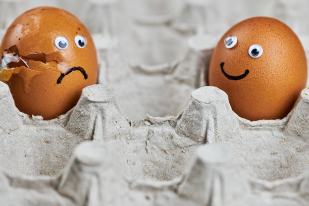 istock Funny egg and sad cracked egg in paper egg tray 1282734342