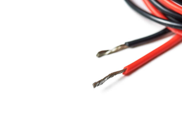 Isolated aluminum bare wires of electric cable. Red and black wires without insulation for speakers or power. Supply of electricity to device