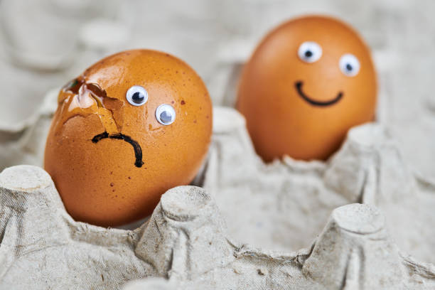 istock Funny egg and sad cracked egg in paper egg tray 1282734487