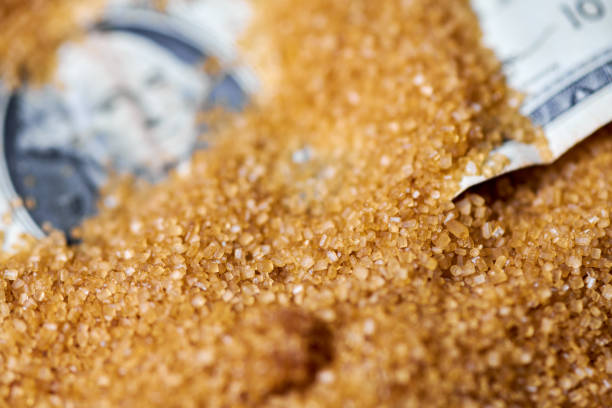 Dollar money in sugar. Sugar export prices, economic concept. Decrease or increase in price of cane sugar production. American dollar in scattering powdered sugar