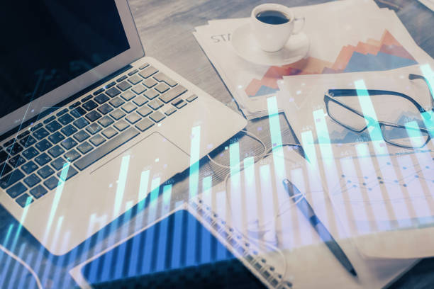 istock Stock market graph and table with computer background. Multi exposure. Concept of financial analysis. 1282735414