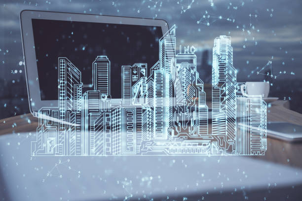 istock Desktop computer background in office and big town buildings hologram drawing. Double exposure. Smart city concept. 1282735545