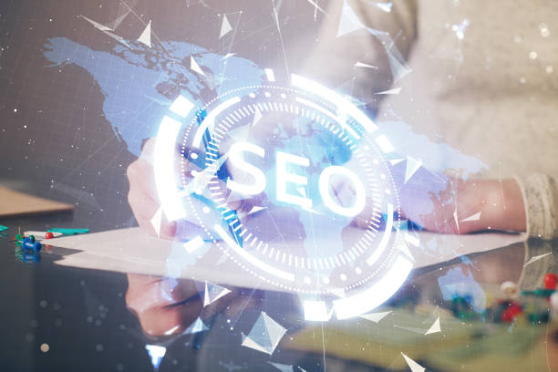 istock Multi exposure of woman's hands making notes with SEO icon. Concept of Search engine optimization 1282735576