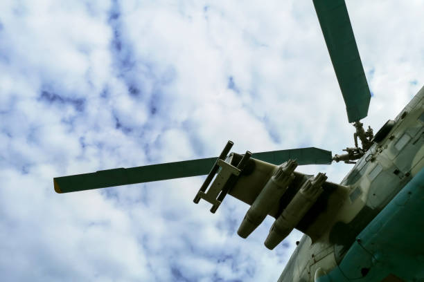 istock Helicopter flying under sky covered with clouds. Flying military helicopter. 1282736731