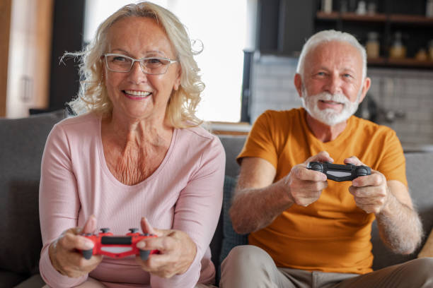 istock Senior couple at home playing video games 1282736893