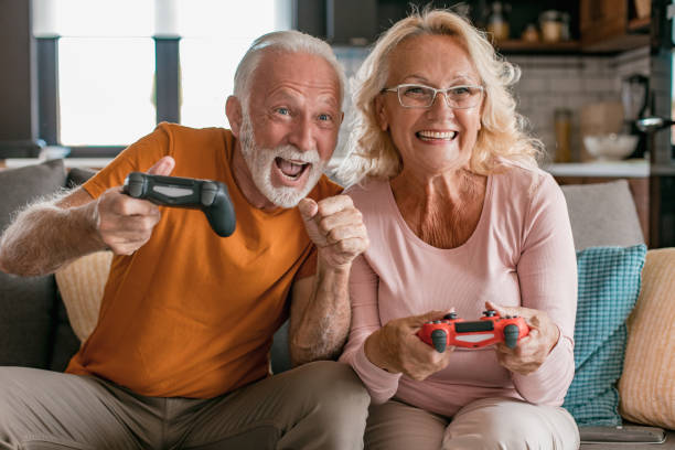 istock Senior couple at home playing video games 1282737740