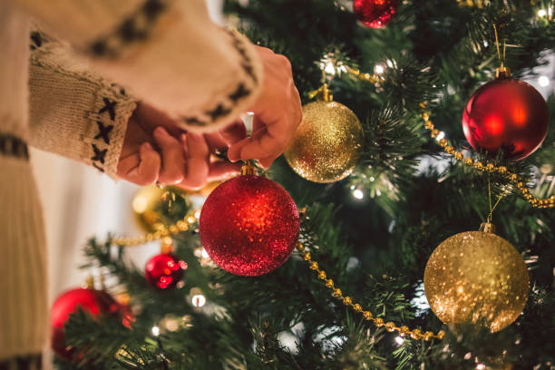 istock Young woman decorating the Christmas tree 1282737885