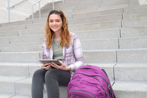 istock Teenaged girl with backpack on campus grounds 1282740017