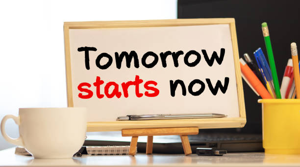 istock Tomorrow starts now written in a notebook with coffee and pen. Motivation concept 1282742546
