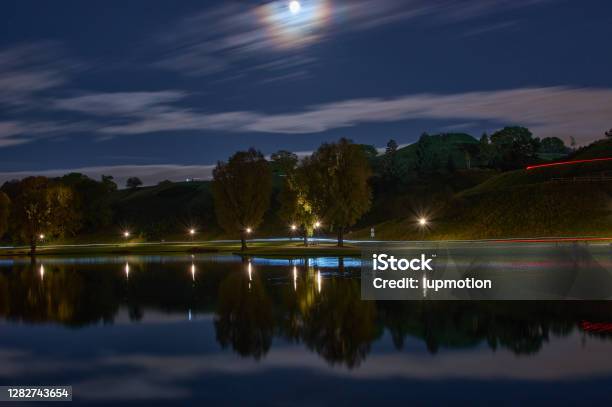Long Exposure Of City Lights And Clouds In A Park By Night Long Exposure Of Light Reflections In A Lake In Munich At Night Stock Photo - Download Image Now