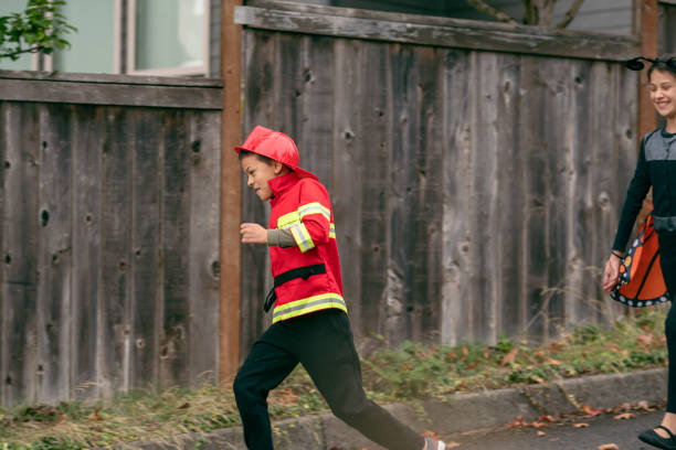 istock Boy dressed as a firefighter trick or treating on Halloween 1282744596