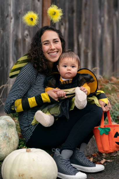 istock Young mother posing with her baby while trick or treating 1282744635