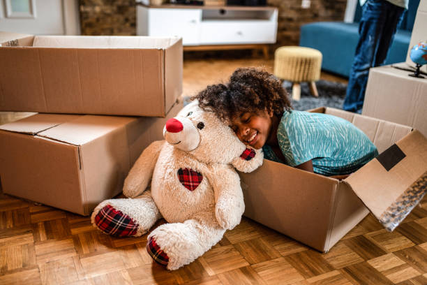 istock Young girl sleeping next to teddy bear in new home. 1282744955