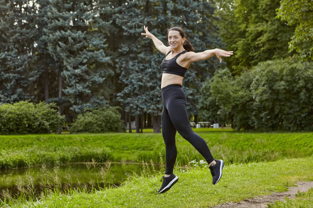 istock Athletic woman is making exercises on open air for healthy. 1282745928