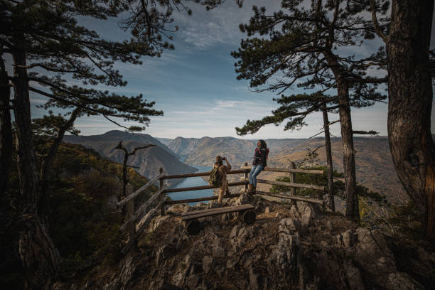 istock Two young female hikers at mountain viewpoint 1282746715