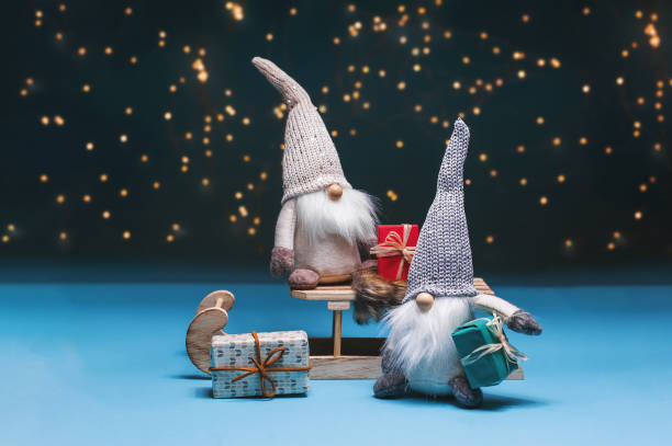 istock Tomte standing against the starry sky with gifts and sledges 1282746802