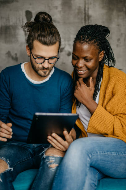 istock Young mixed race couple doing some online shopping and chat on a digital tablet 1282747649