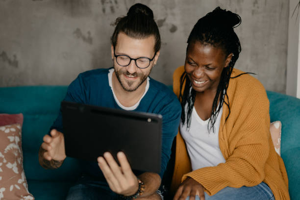 istock Young mixed race couple doing some online shopping and chat on a digital tablet 1282747765