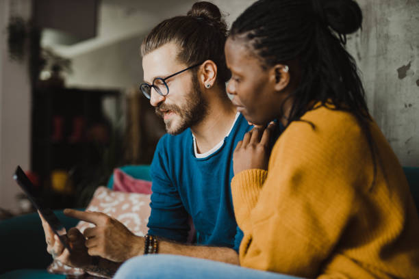 istock Young mixed race couple doing some online shopping and chat on a digital tablet 1282747800