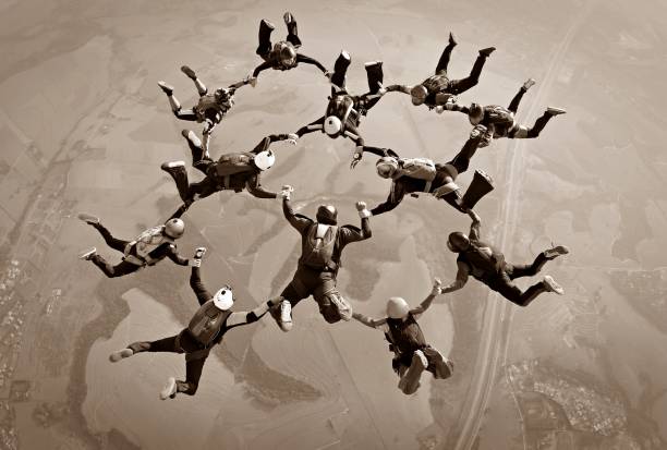 skydivers team in sepia - extreme sports audio imagens e fotografias de stock