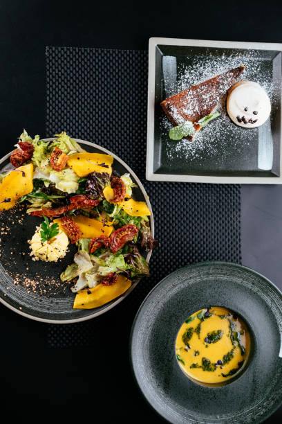 istock autumn salad with pumpkin and sun-dried tomatoes on a black back 1282750626
