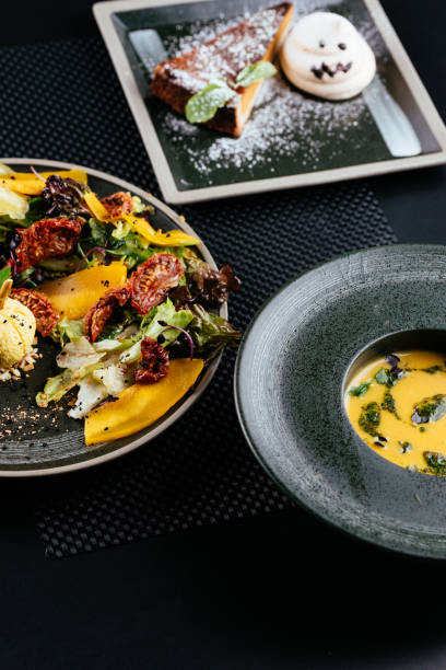 istock autumn salad with pumpkin and sun-dried tomatoes on a black back 1282750630