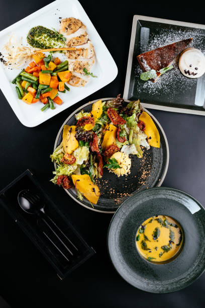 istock autumn salad with pumpkin and sun-dried tomatoes on a black back 1282750644