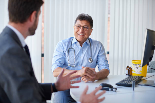 friendly gp male health chat rolled up sleeves stock pictures, royalty-free photos & images