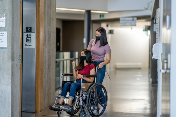 istock Female university student in a wheelchair using the elevator 1282751573