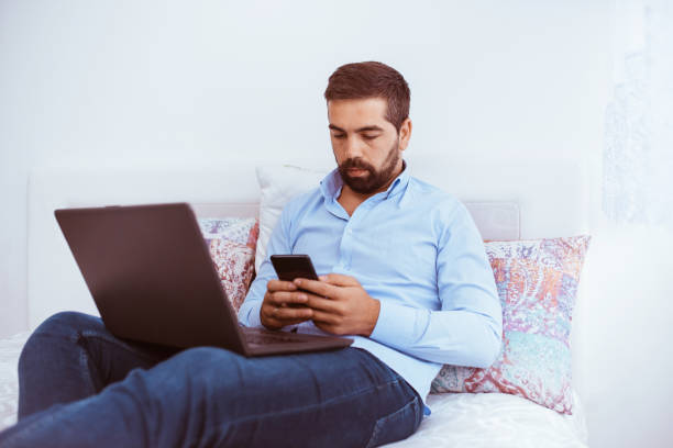 istock Young man works at home on a laptop 1282752516