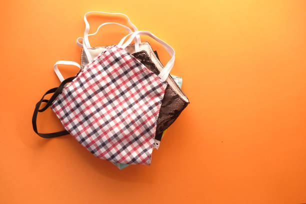 istock homemade face masks on orange background top down 1282753378