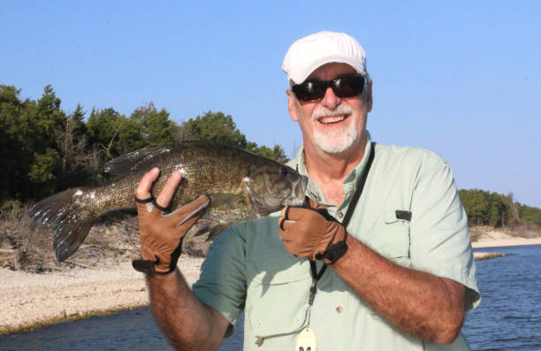 istock Fisherman with Smallmouth Bass 1282753537